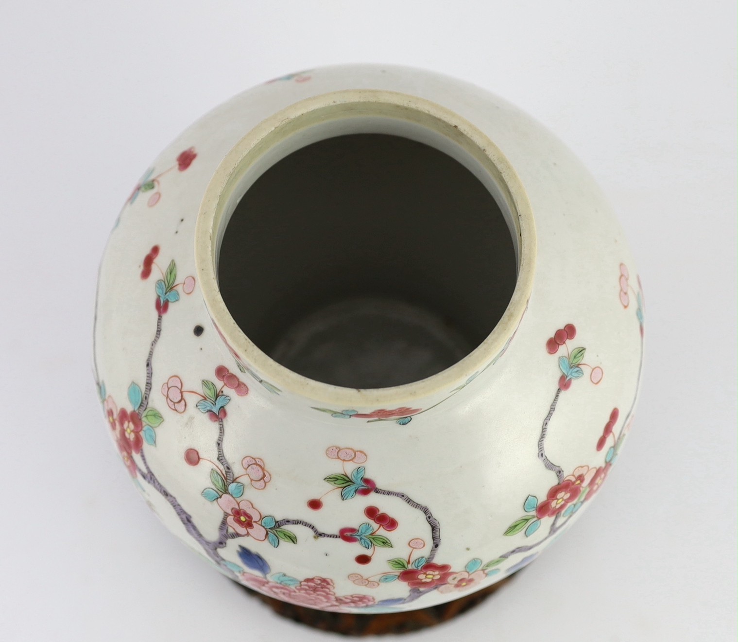 A Chinese famille rose fencai 'pheasant' vase and cover, 19th century, Jiaqing-Daoguang period, 28cm high, small faults to cover, wood stand